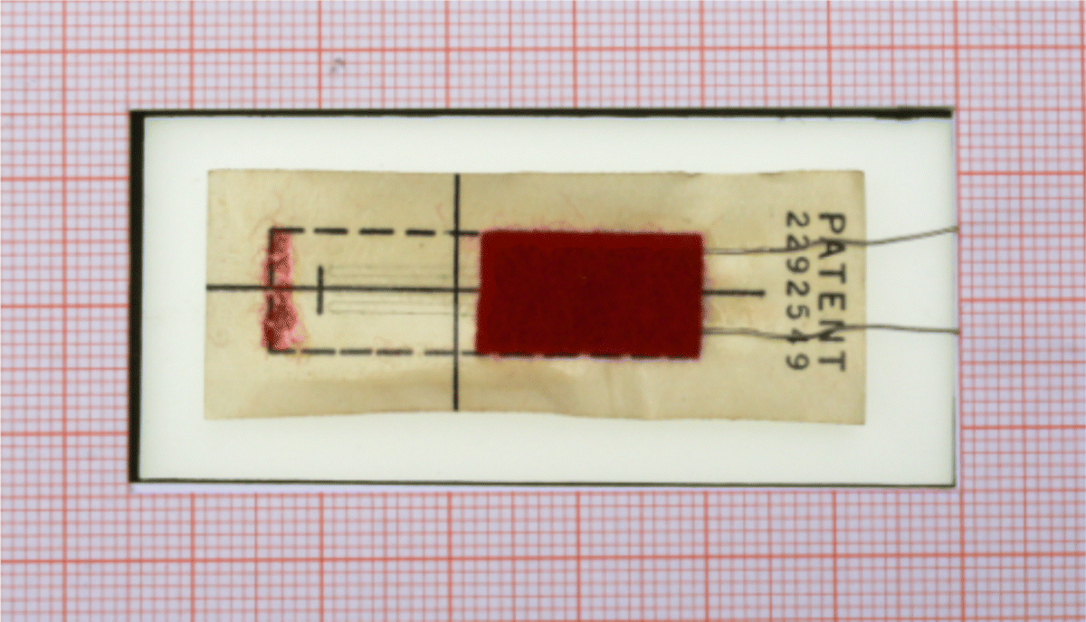 Figure depicting SR-4 strain gage with paper carrier from 1941. The protective felt layer is half removed.