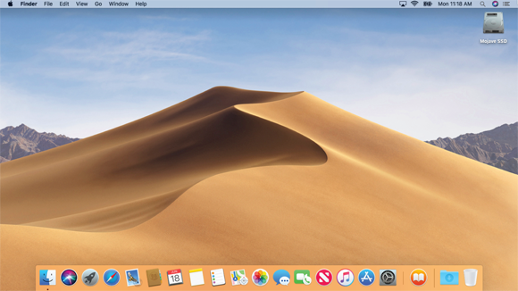 Image of the picture of a sand dune displayed on the MacOS Mojave desktop screen of a computer.